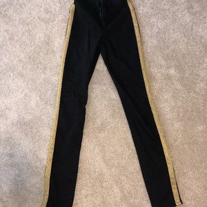 Skinny black jeggings with gold strip